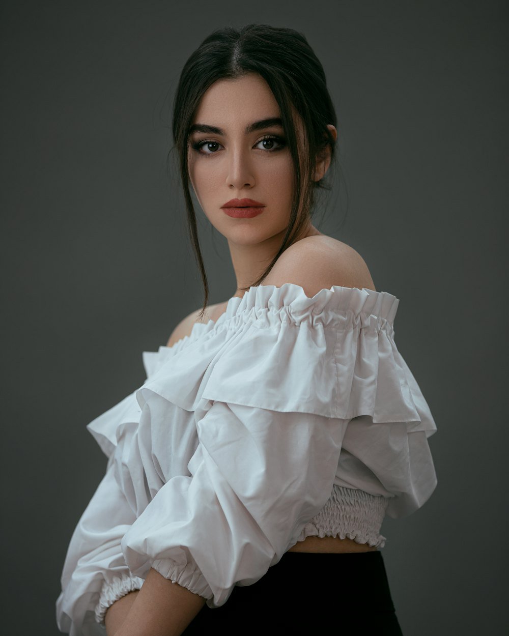 Woman in a white dress styled for a refined fashion edit